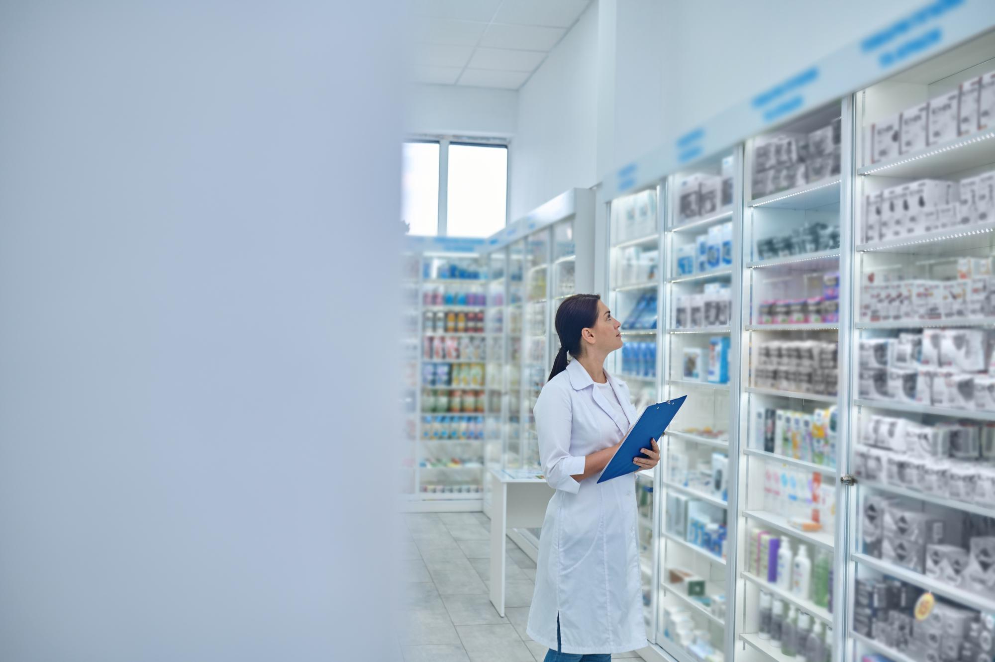 pharmacist checking medicines drugstore for inventory management systems
